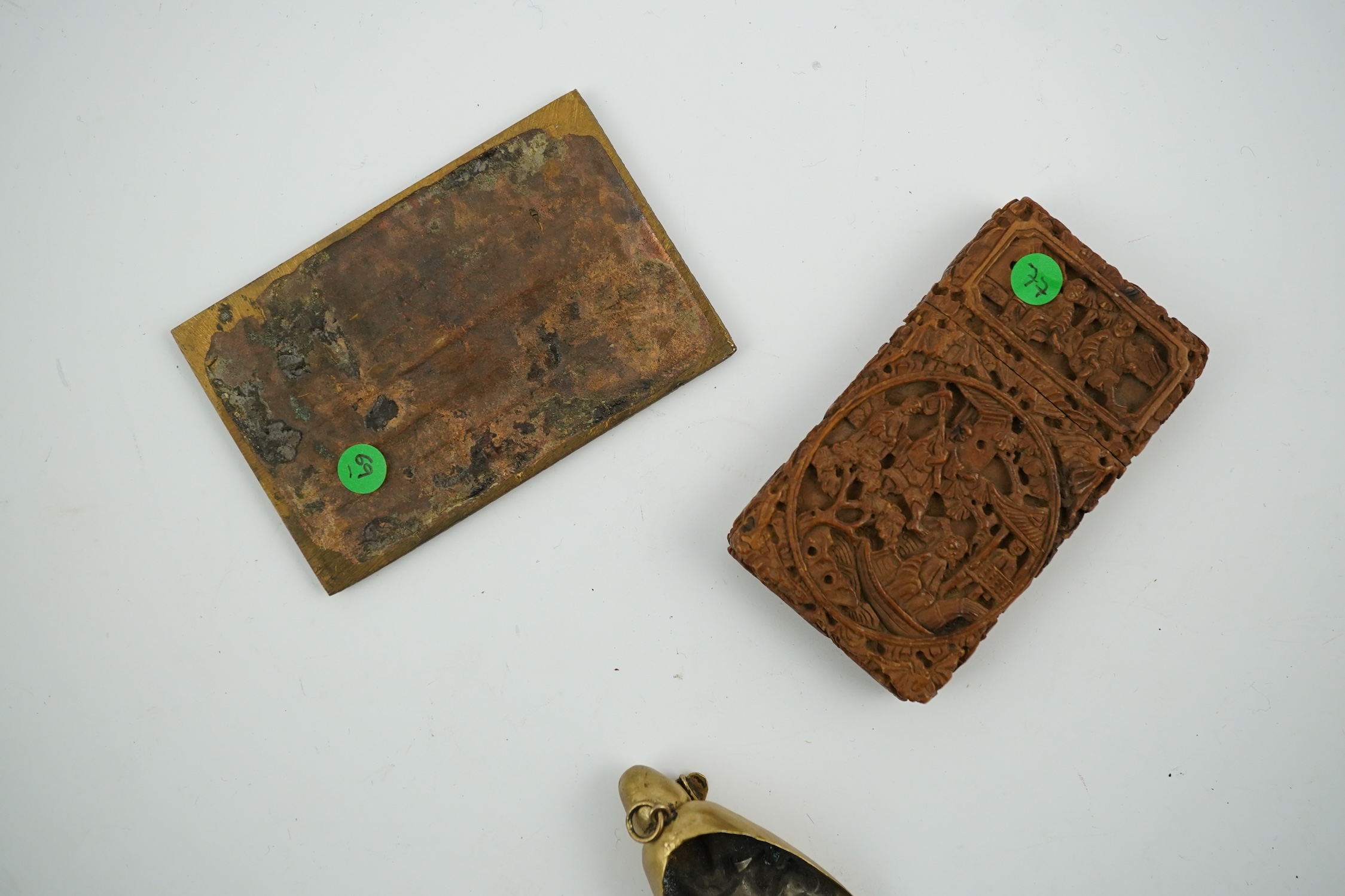 A Chinese carved sandalwood card case, a bronze relief cast and chased plaque and a gilt metal Shou Lao pendant, card case 7.5cm high. Condition - good